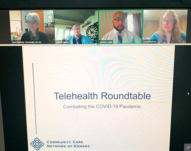 Jonathan Smith (second from right) is helping Kansas health centers successfully implement telehealth services for their patients.